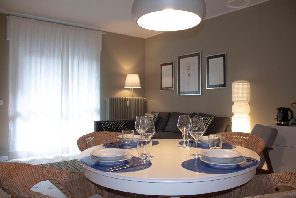 a dining room table with plates and wine glasses on it at Trilocale in centro a Chiesa Valmalenco in Chiesa in Valmalenco