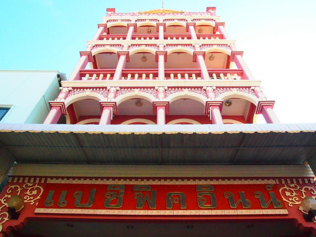 a tall red building with chinese writing on it at Pacific Inn in Phuket Town