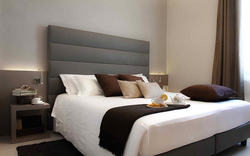 Postel nebo postele na pokoji v ubytování Hotel Chivasso