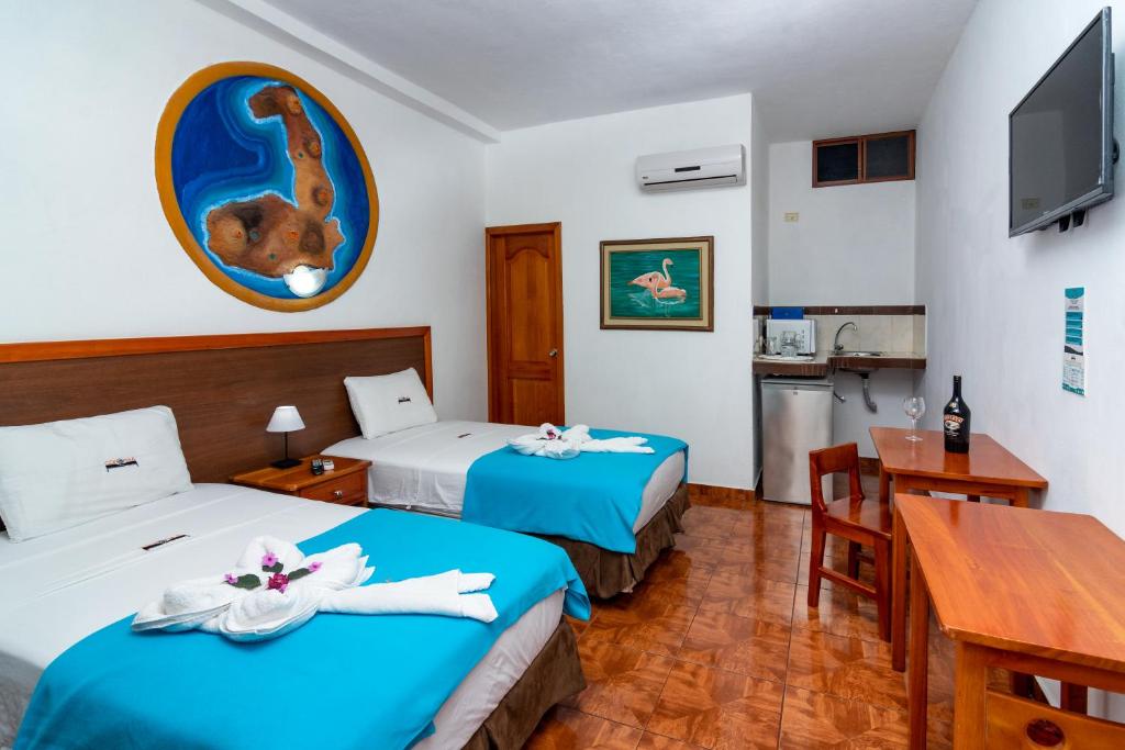 Postel nebo postele na pokoji v ubytování Hotel Coloma Galapagos