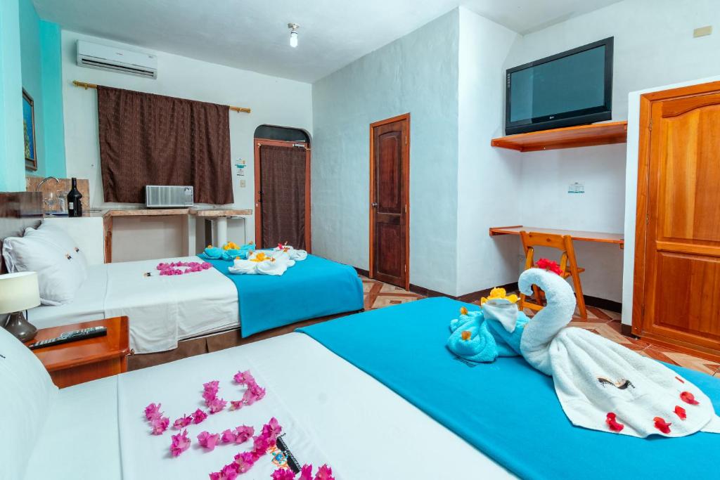 Postel nebo postele na pokoji v ubytování Hotel Coloma Galapagos
