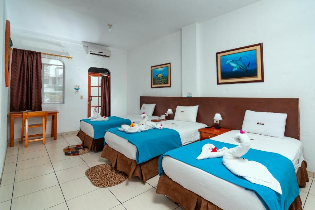 Postel nebo postele na pokoji v ubytování Hotel Coloma Galapagos