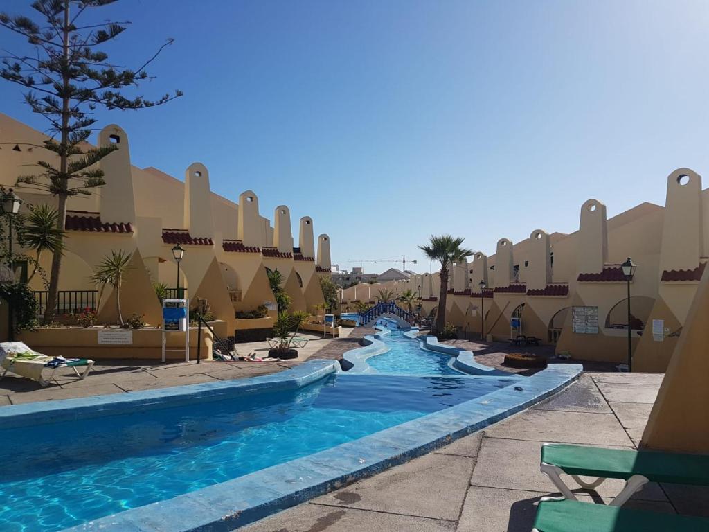 a pool at a resort with two water slides at Mare verde 2 in Adeje