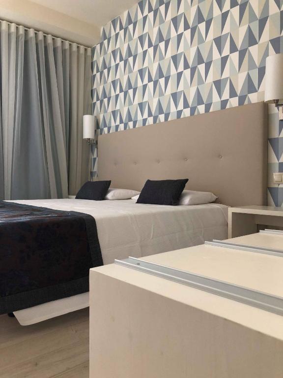 Postel nebo postele na pokoji v ubytování Ouril Hotel Julia