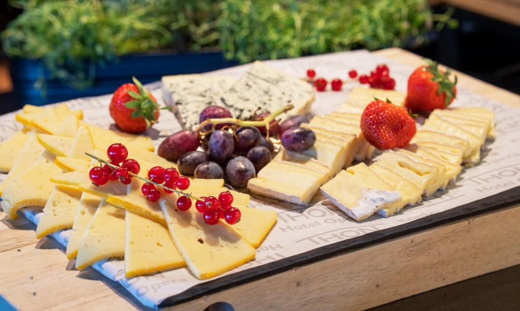 a tray of cheese and fruit on a table at Thon Hotel Opera in Oslo