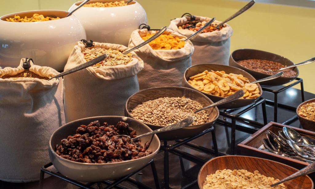 a table with many bowls of different types of food at Thon Hotel Opera in Oslo