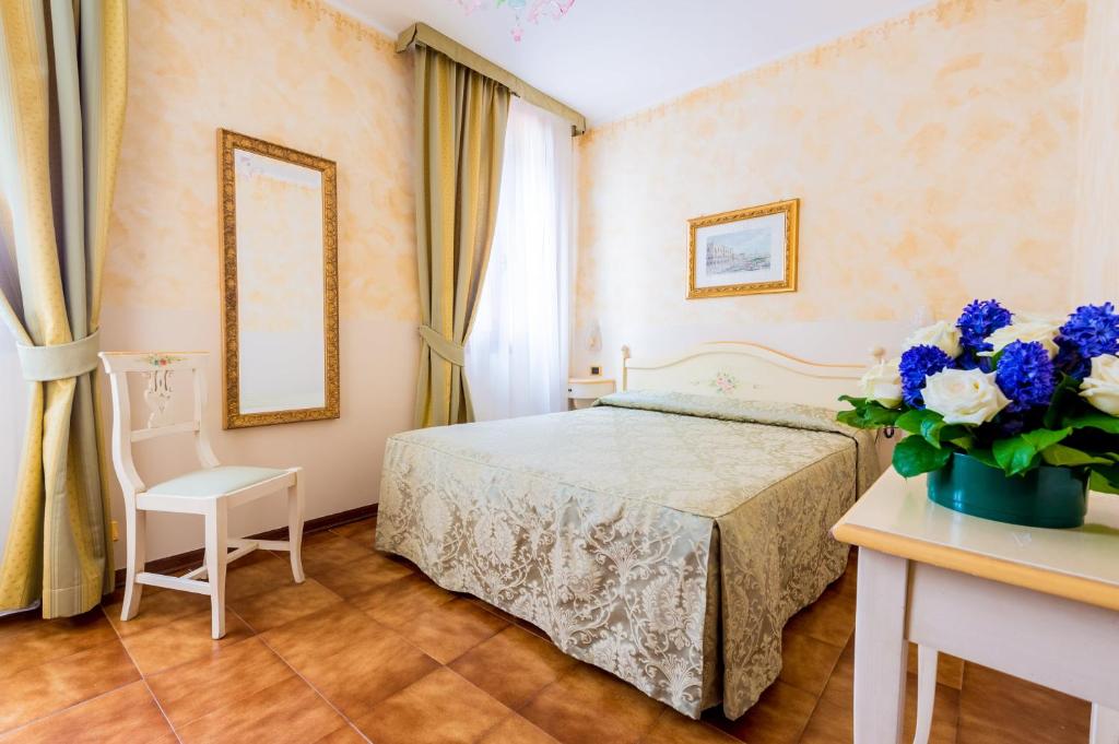 Postel nebo postele na pokoji v ubytování Hotel Mercurio