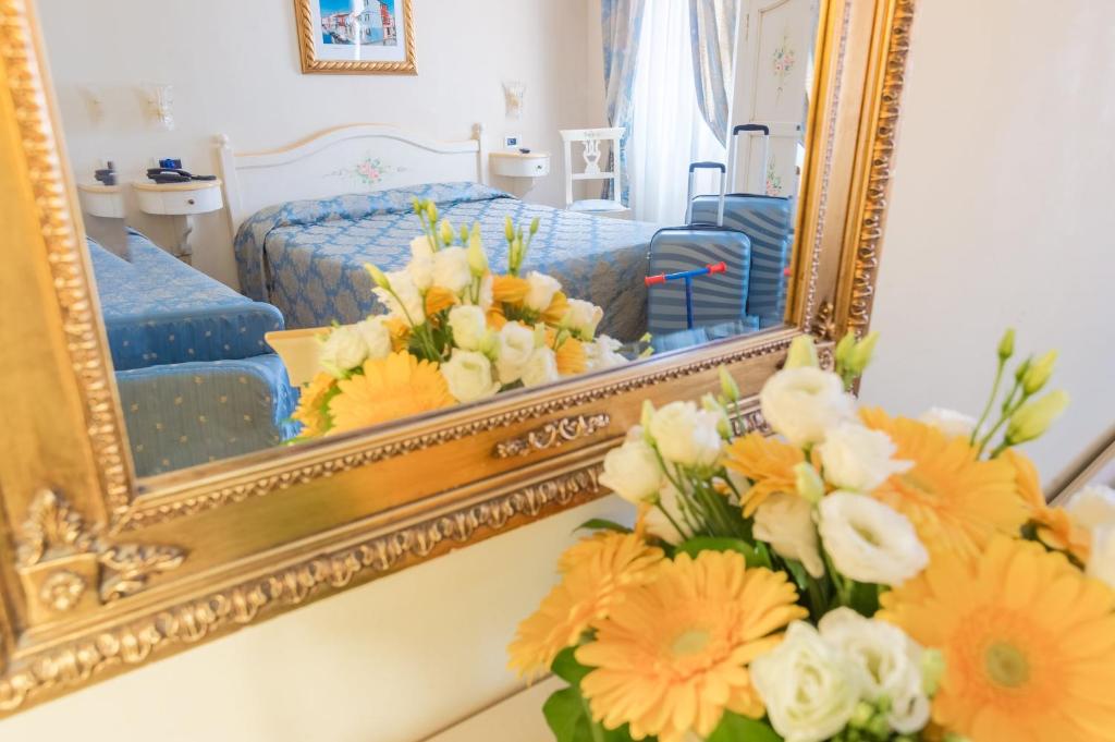 Postel nebo postele na pokoji v ubytování Hotel Mercurio