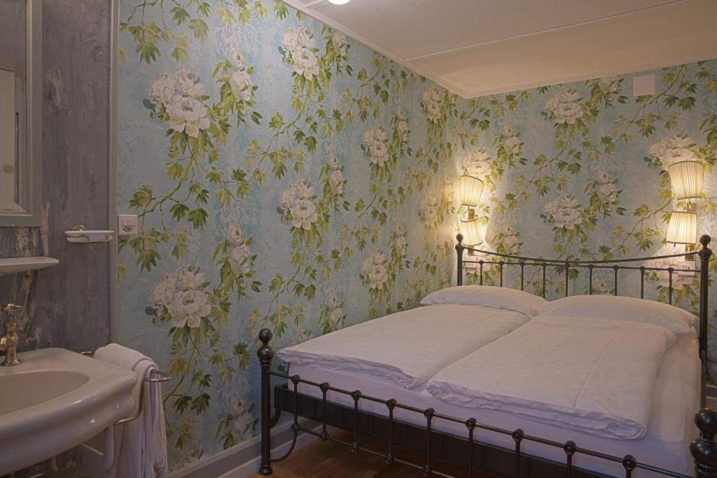 a bedroom with a bed and a sink at Alplodge in Interlaken