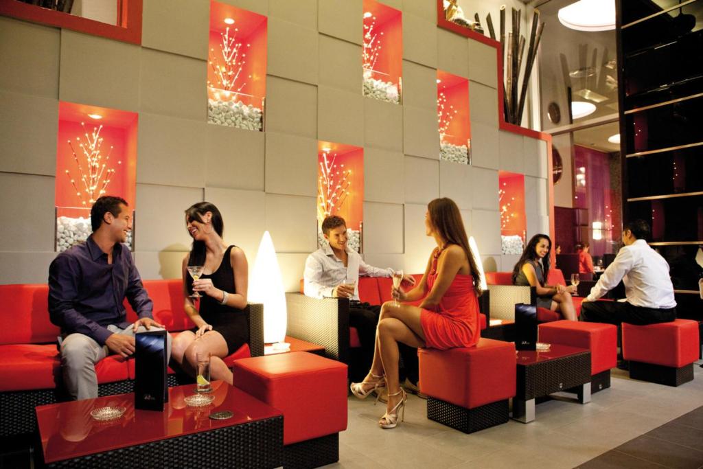 a group of people sitting in a lobby at Riu Plaza Panamá in Panama City