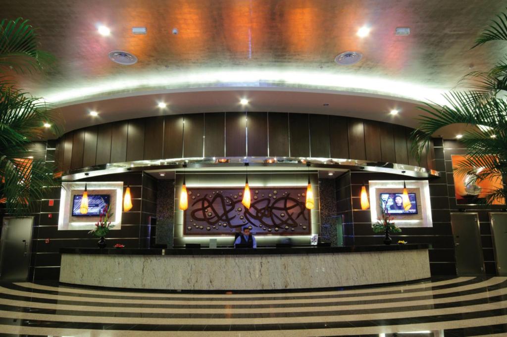 a man sitting in front of a stage in a building at Riu Plaza Panamá in Panama City