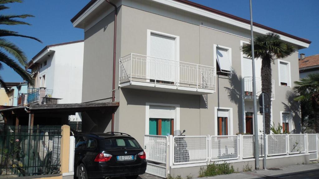 a black car parked in front of a white building at CASA FLAMINIA in Pesaro