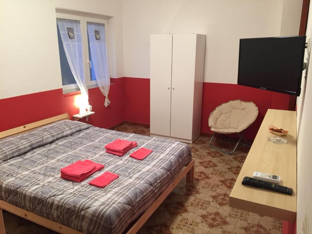 - une chambre avec un lit et des serviettes rouges dans l'établissement Sunset B&B Pompei, à Pompéi