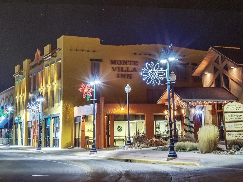 a building with christmas lights on a street at night at Monte Villa Hotel in Monte Vista