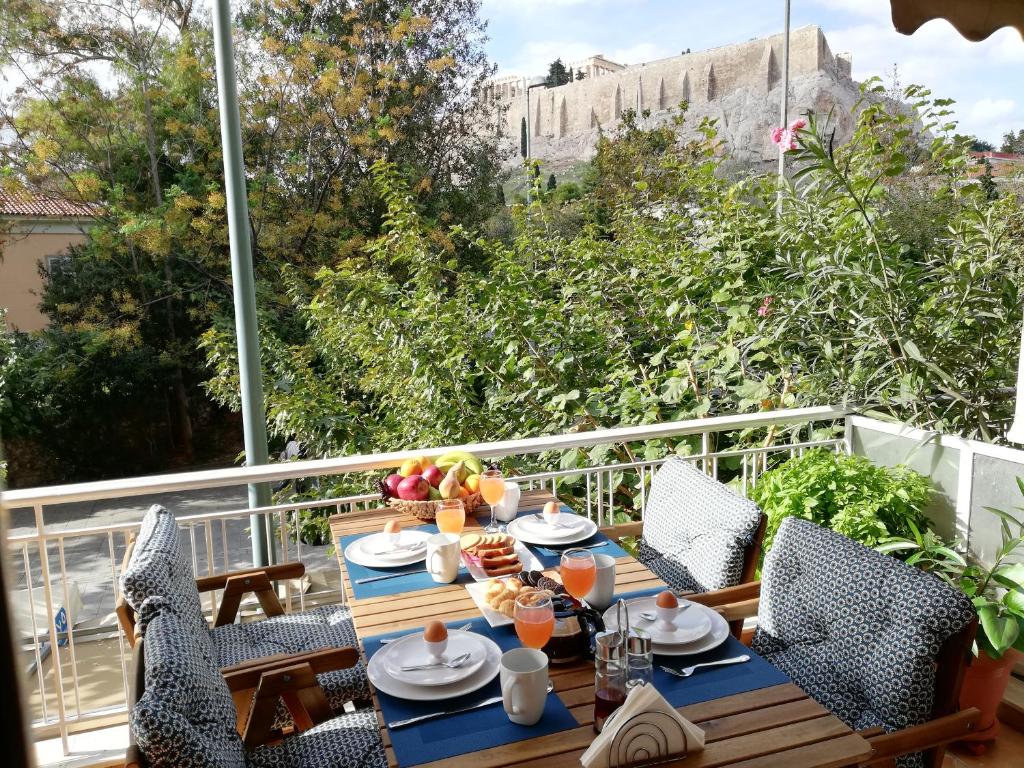 a table with food on top of a balcony at Parthenon View Apt in Athens