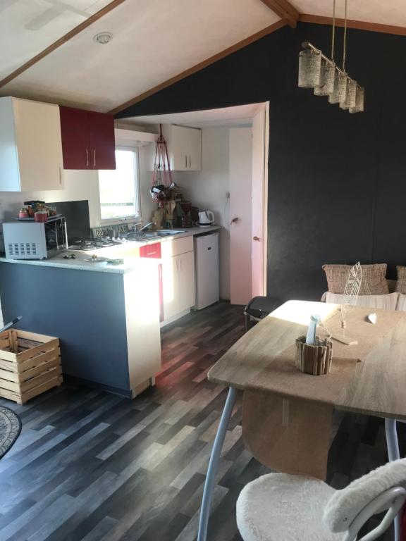 een keuken en een woonkamer met een tafel. bij LA NOALHA INSOLIT' in Lanouaille