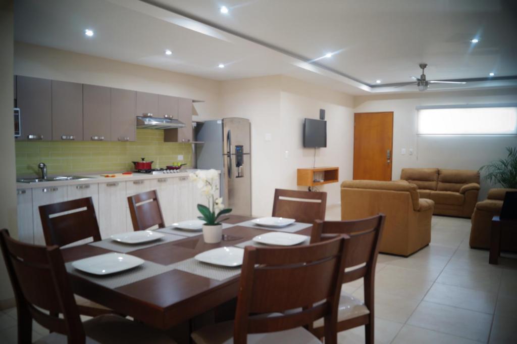a kitchen and dining room with a table and chairs at Casa Luna Suites in La Paz