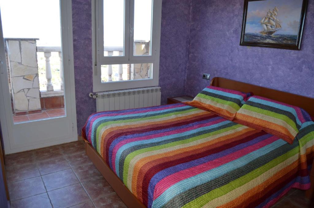 A bed or beds in a room at Apartamentos Matraca