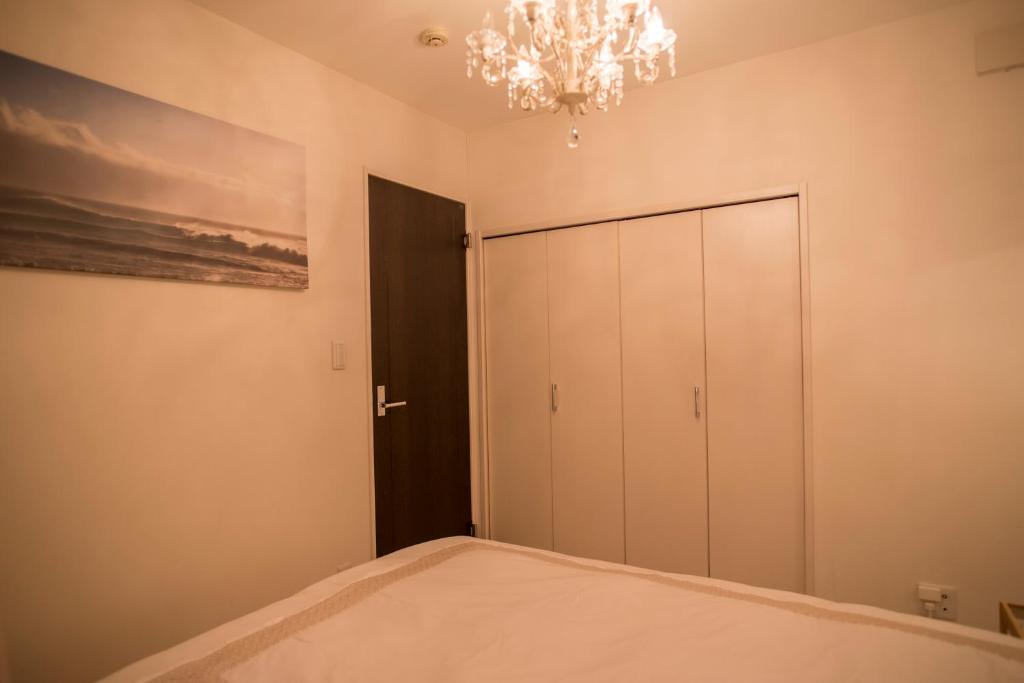 Postel nebo postele na pokoji v ubytování COCO Shinjuku HOTEL