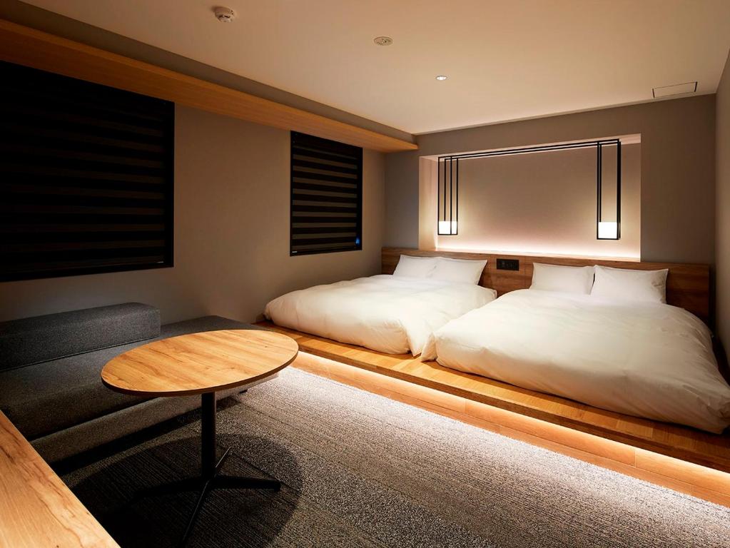 Postel nebo postele na pokoji v ubytování hotel androoms Shin-Osaka