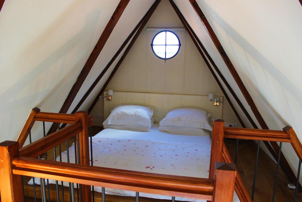 a bedroom with a bed in the attic at Amsterdam Jewel Canal Apartments in Amsterdam