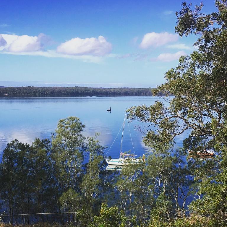 a boat in the middle of a large lake at SilverWaters Waterfront Accommodation Lake Macquarie in Morisset East