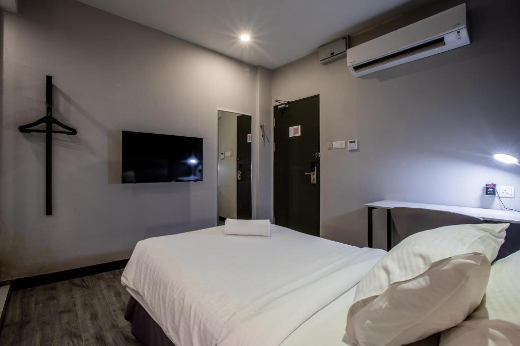 Postel nebo postele na pokoji v ubytování The Leverage Business hotel (Skudai)
