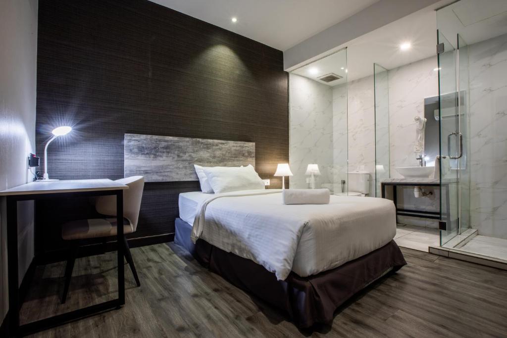 Postel nebo postele na pokoji v ubytování The Leverage Business hotel (Skudai)