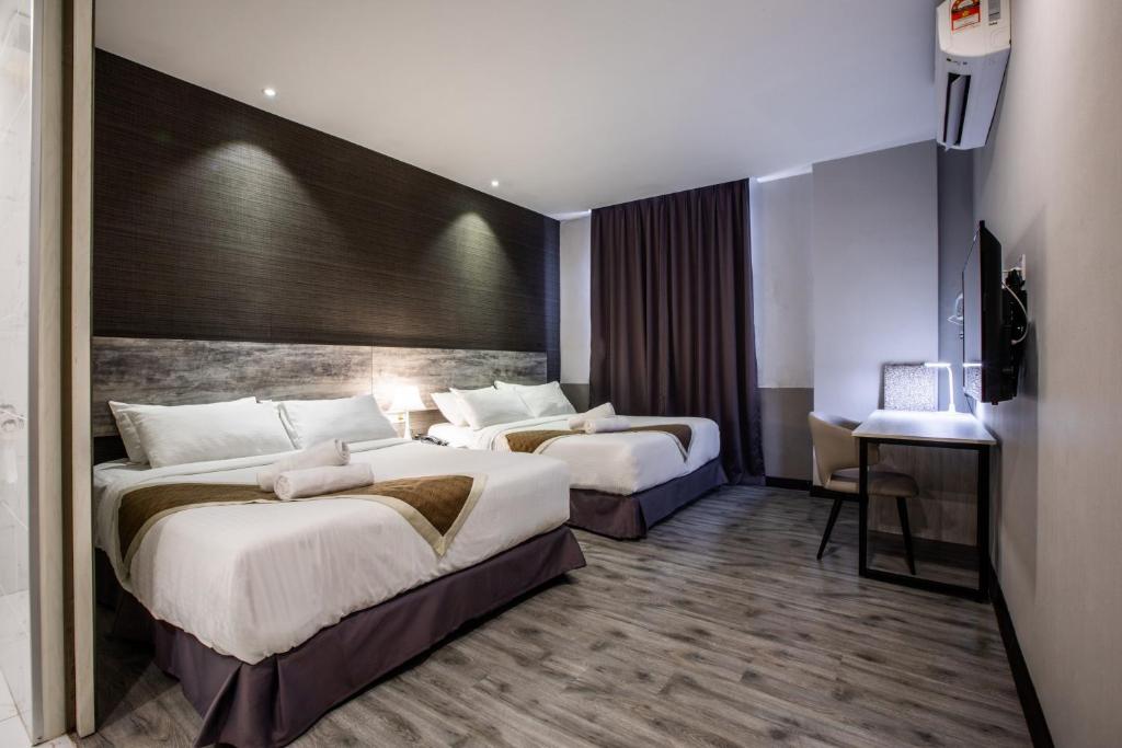 Postel nebo postele na pokoji v ubytování The Leverage Business hotel (Skudai)