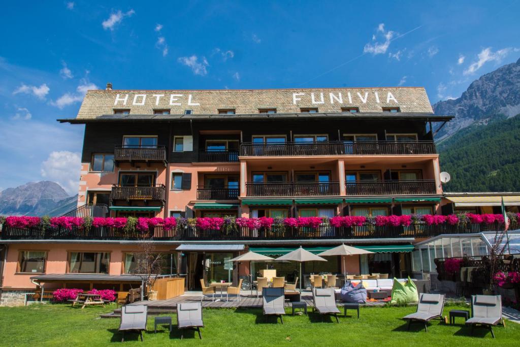 
a large building with a balcony overlooking the ocean at Hotel Funivia in Bormio
