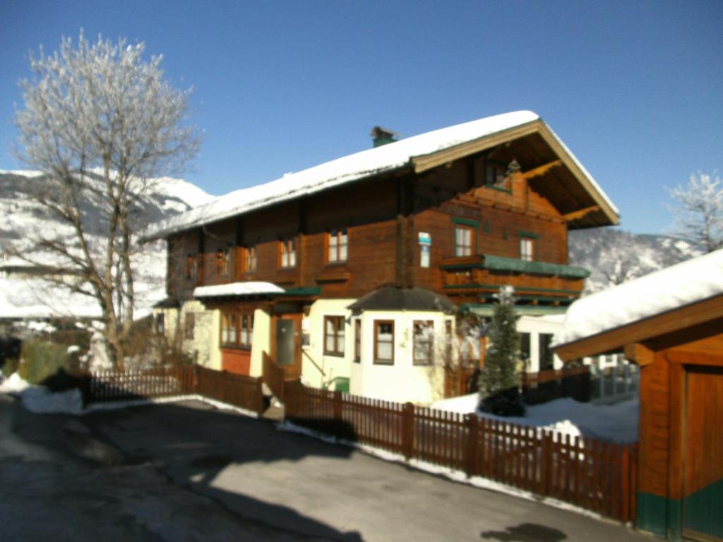 un gran edificio con techo cubierto de nieve en Haus Wieshammer, en Niedernsill