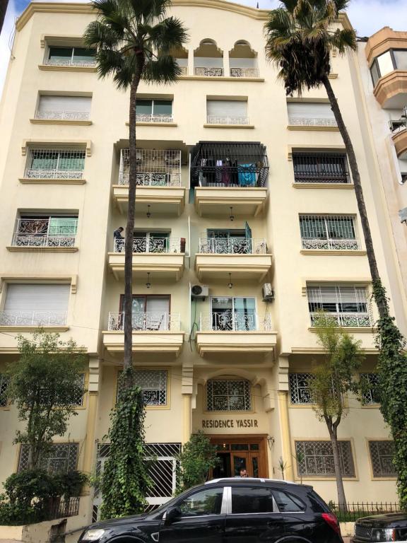 a building with a car parked in front of it at Appart 2 Mars Casablanca in Casablanca