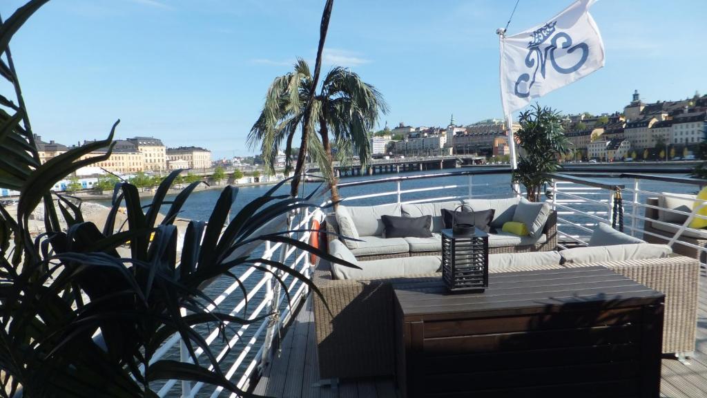 a balcony with a couch on top of a boat at Mälardrottningen Yacht Hotel in Stockholm