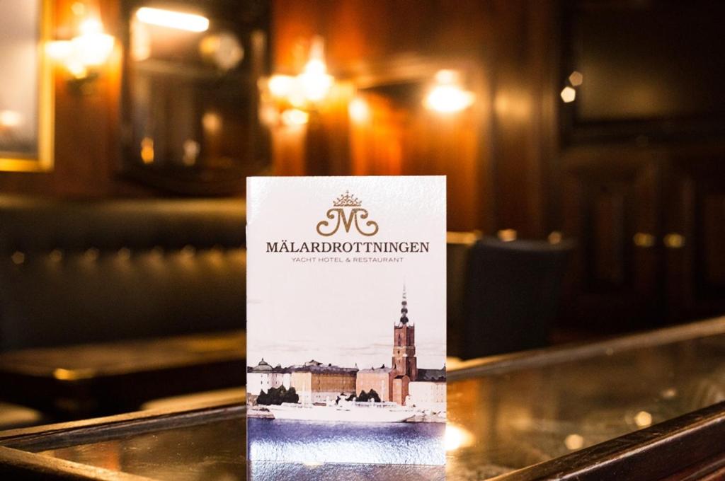 a sign sitting on top of a table at Mälardrottningen Yacht Hotel in Stockholm