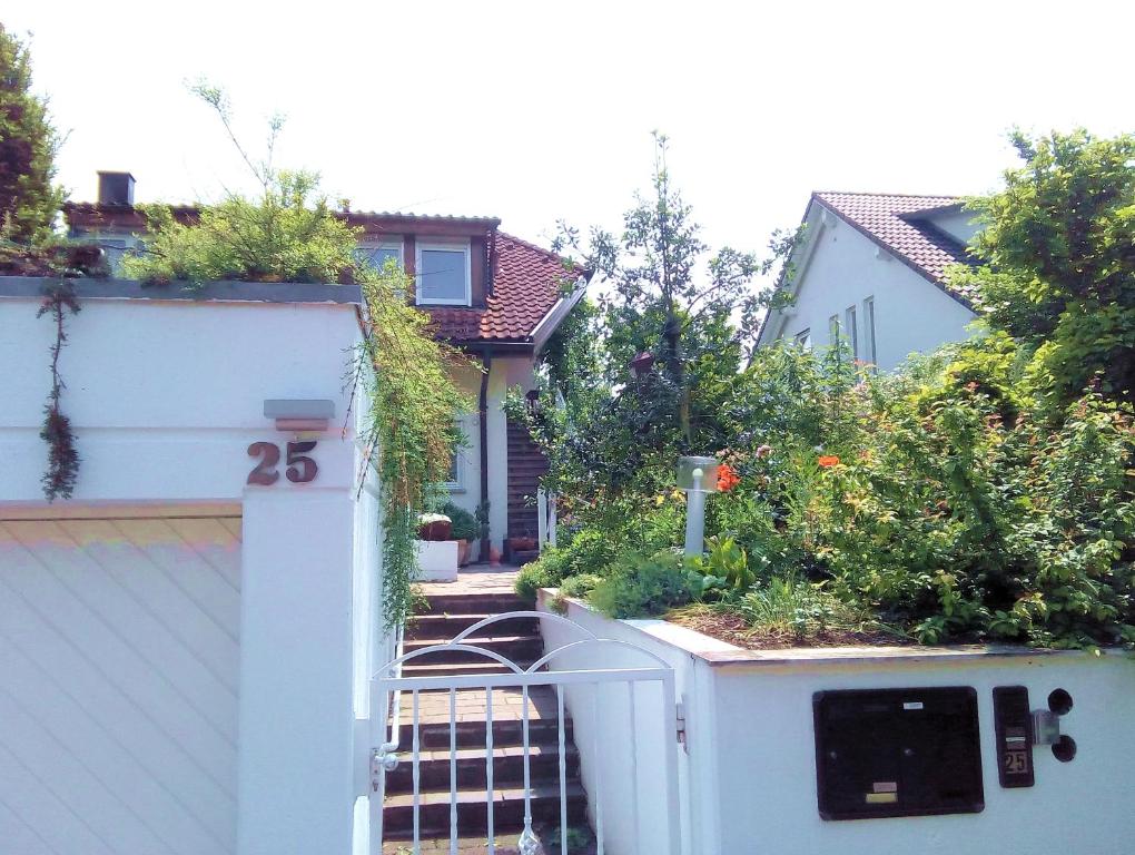 ein Haus mit einem weißen Tor mit Pflanzen darauf in der Unterkunft Ferienwohnung Wiedmann in Tübingen