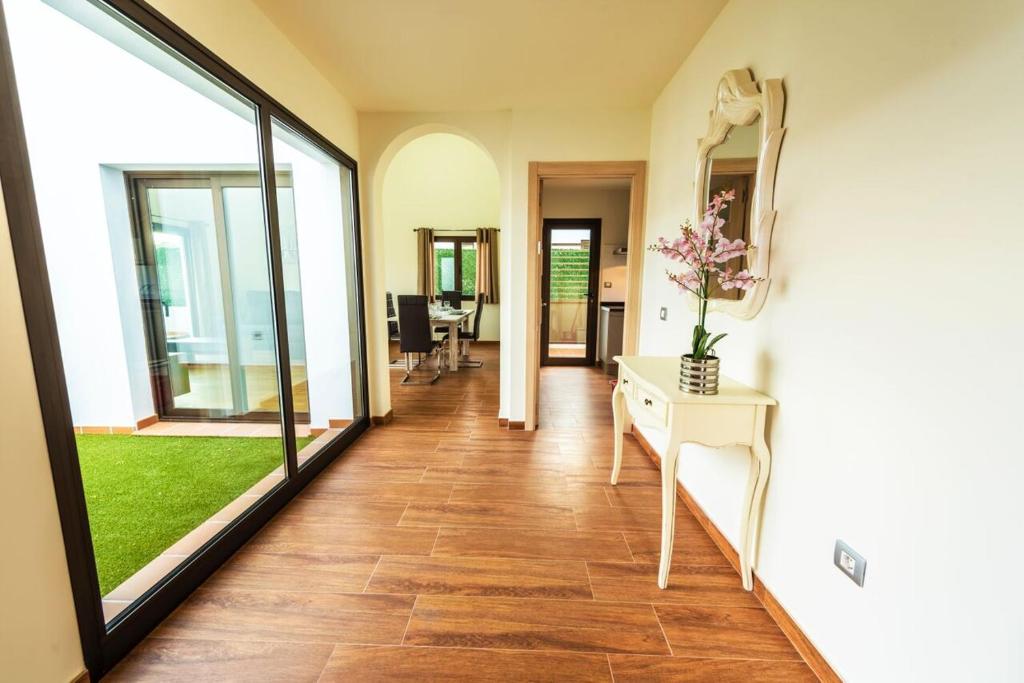 a hallway of a house with a table and a mirror at VILLA DELICIOUS GOLF in Caleta De Fuste