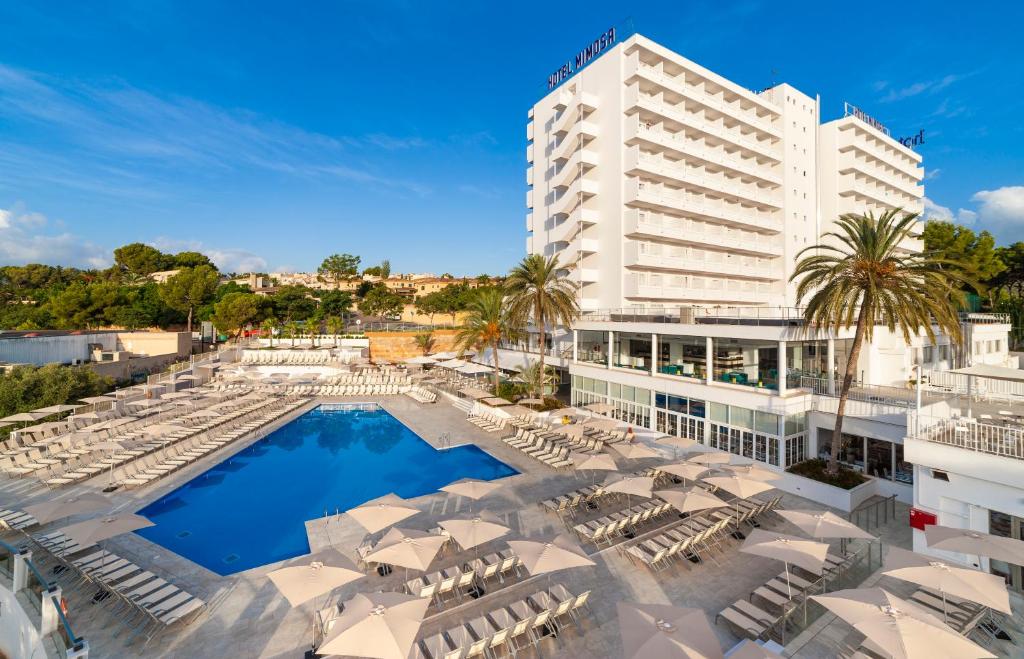 a view of a hotel with lounge chairs and a pool at Globales Mimosa in Palmanova