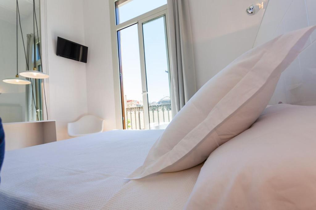 Posteľ alebo postele v izbe v ubytovaní Hostal Argo