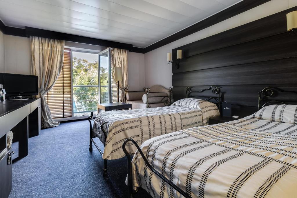 Postel nebo postele na pokoji v ubytování Bakkara Hotel