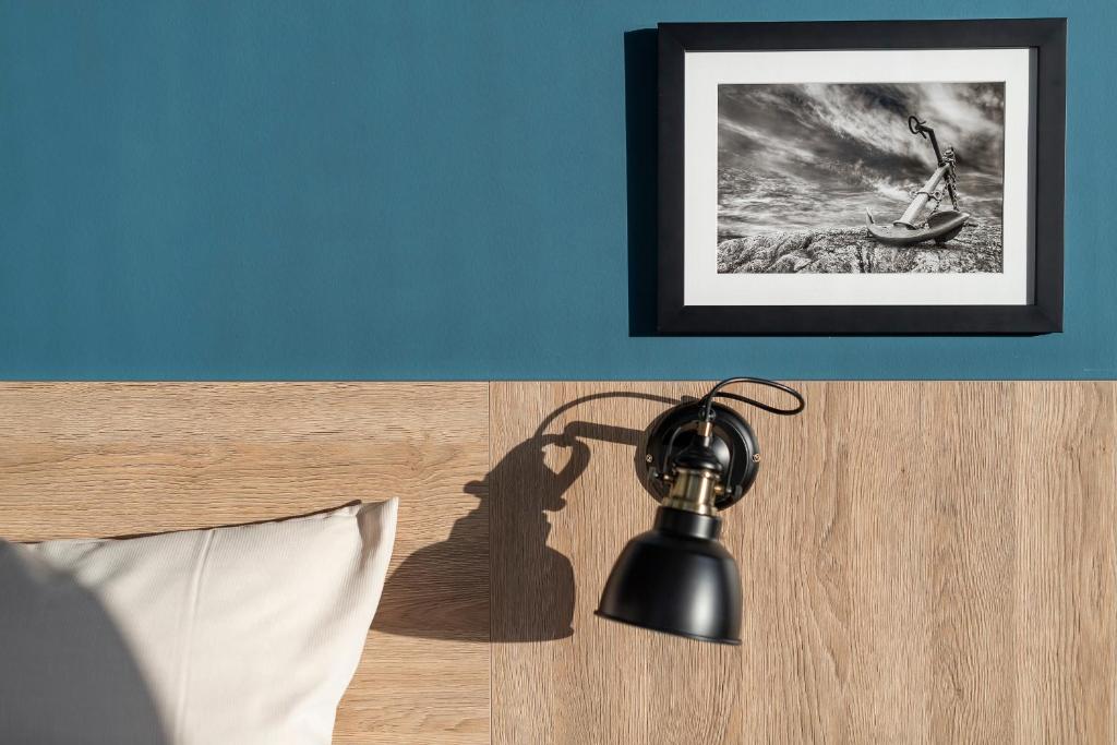 a shadow of a lamp on the side of a bed at HARBR. hotel Konstanz in Konstanz