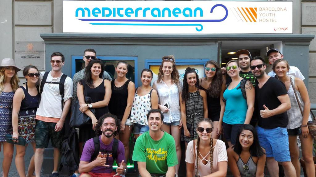 a group of people posing for a picture in front of a truck at Mediterranean Hostel Barcelona in Barcelona