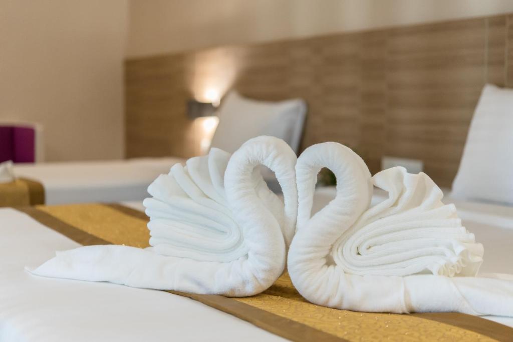Postel nebo postele na pokoji v ubytování Paragon Grand Resort