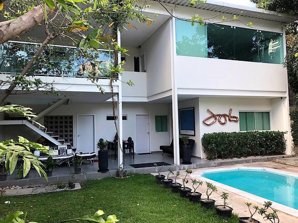 una casa con piscina frente a ella en Pousada Flat Hotel em Casa Forte, en Recife
