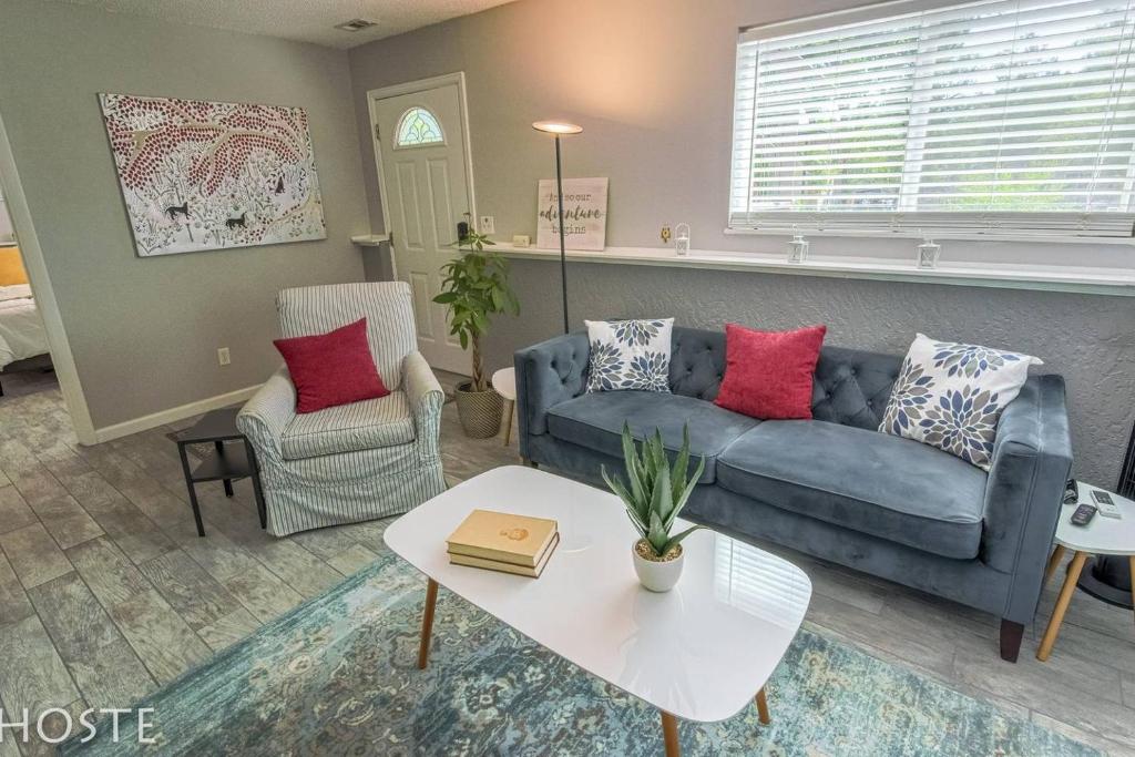 a living room with a blue couch and a table at 2BR Garden-level Great Outdoors Dog Friendly in Colorado Springs
