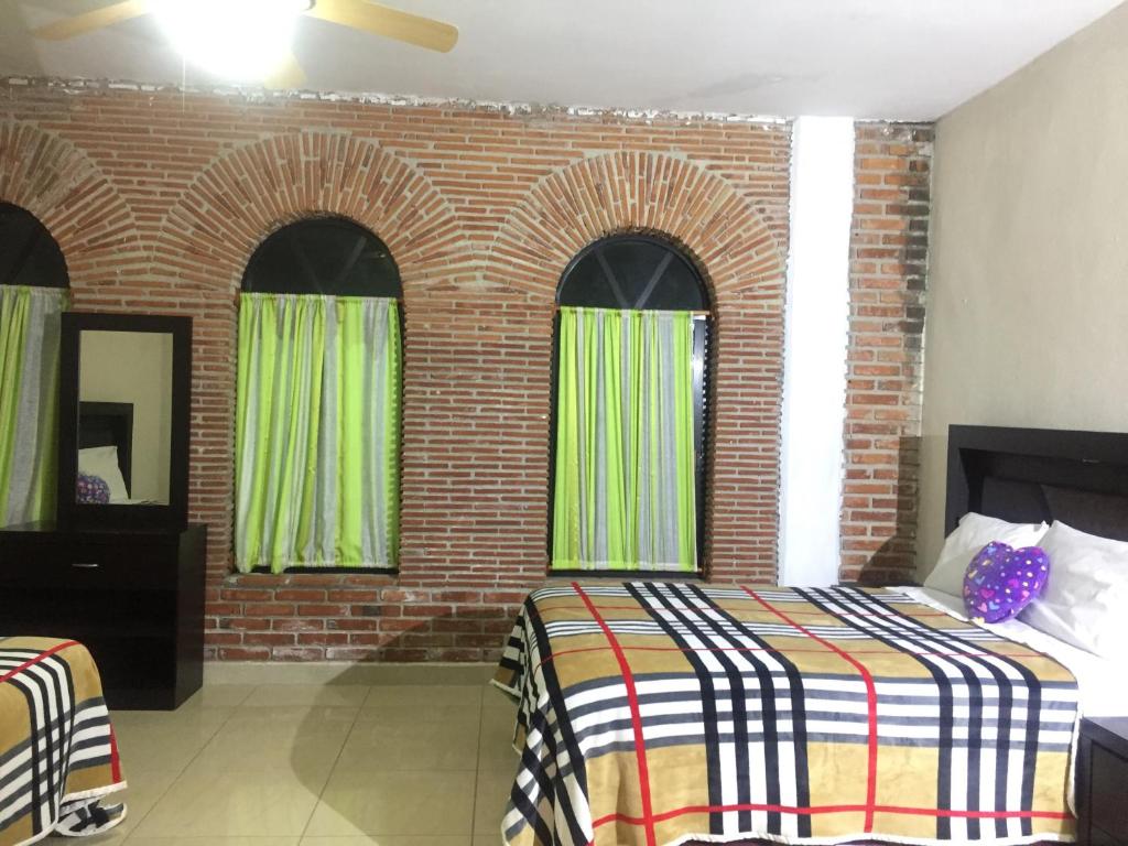 Postel nebo postele na pokoji v ubytování Hotel Coatlicue