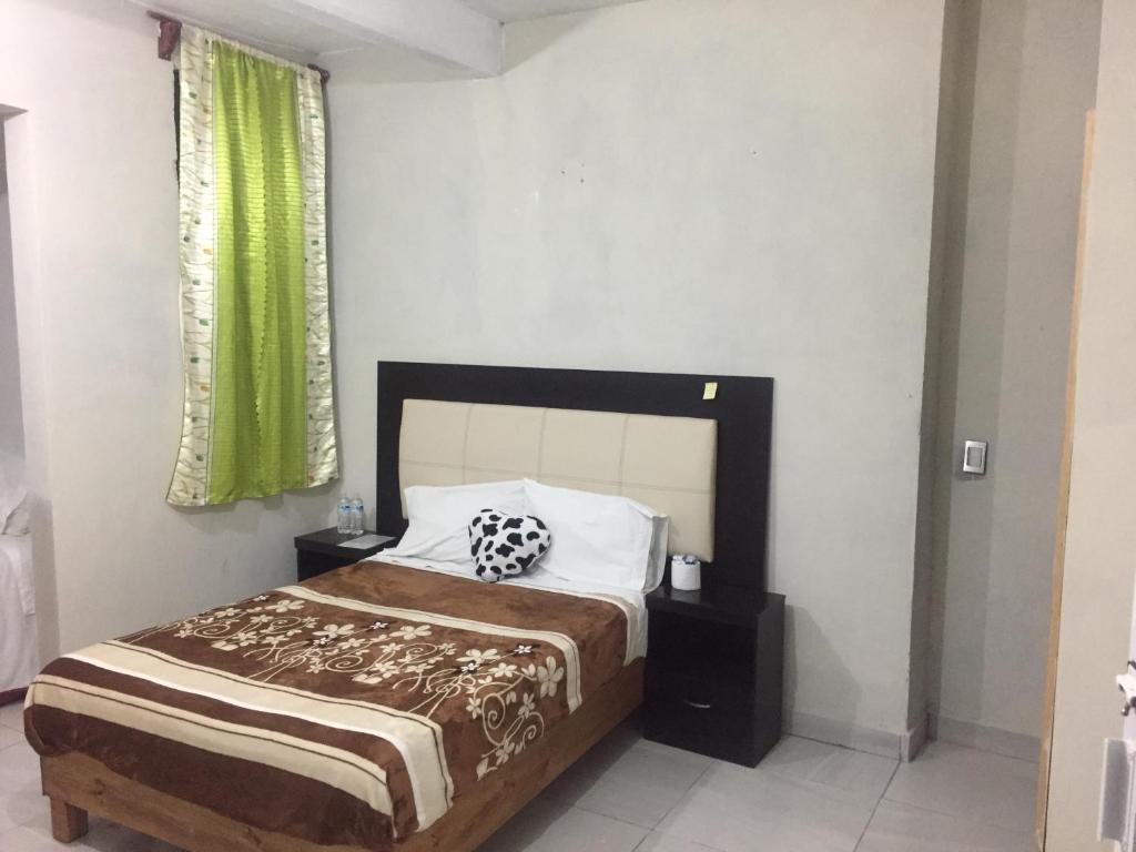 Postel nebo postele na pokoji v ubytování Hotel Coatlicue