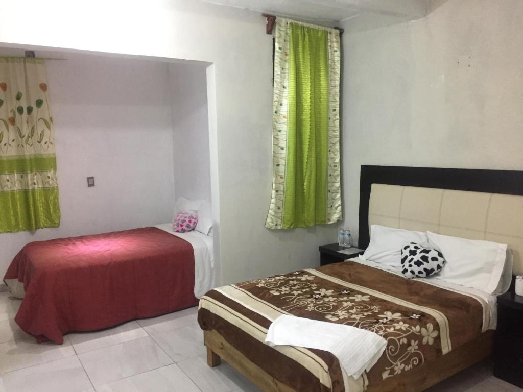 Postel nebo postele na pokoji v ubytování Hotel Coatlicue