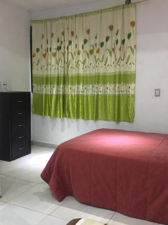 Postel nebo postele na pokoji v ubytování Hotel Coatlicue