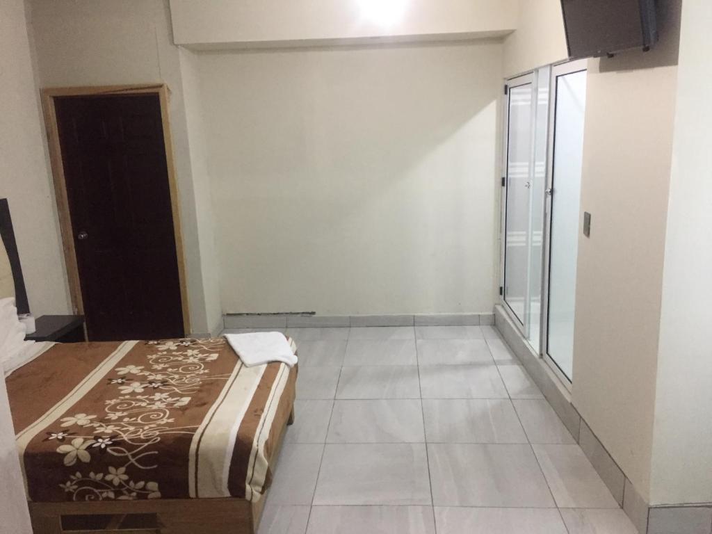 Postel nebo postele na pokoji v ubytování Hotel Coatlicue