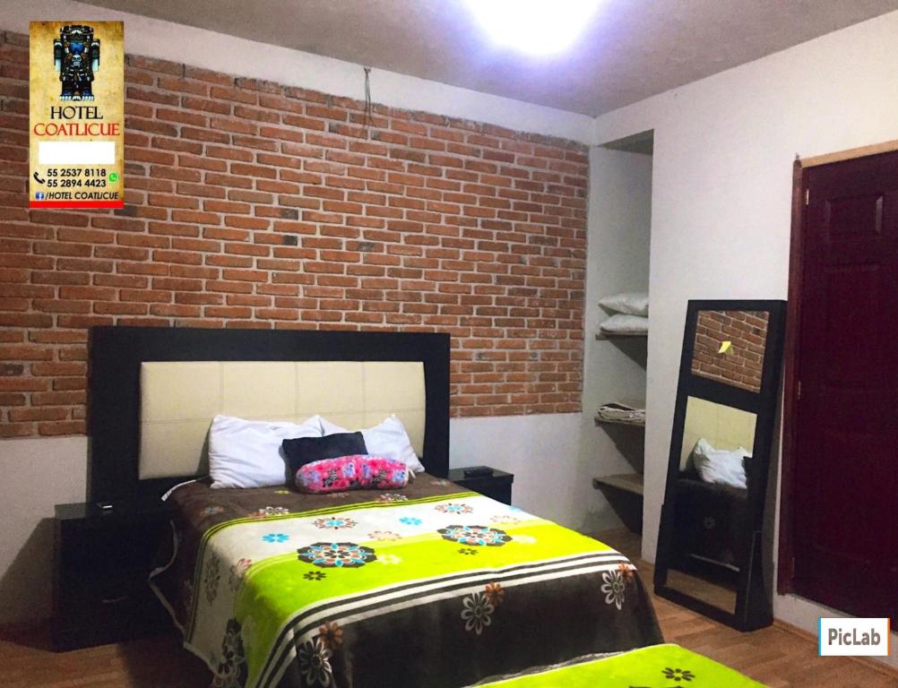 Postel nebo postele na pokoji v ubytování Hotel Coatlicue